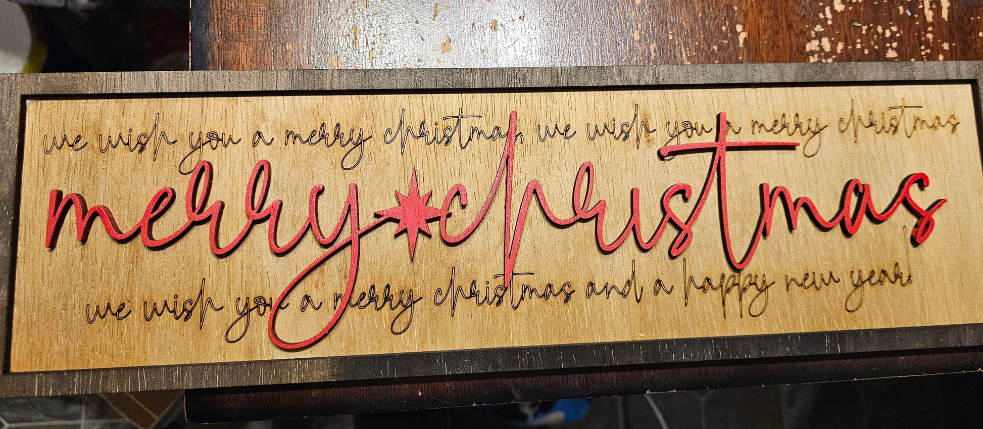 Wooden sign with engraved and red raised lettering reading 'Merry Christmas' and festive wishes, custom decor by BearNugget Customs.