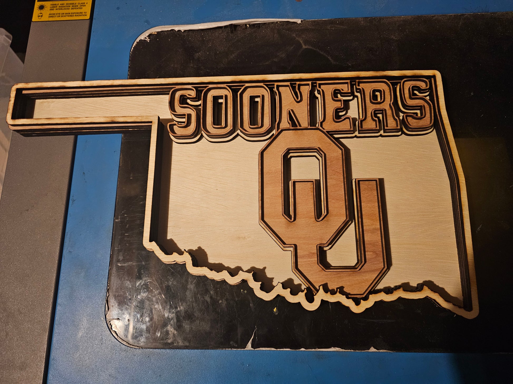 Custom wooden Oklahoma Sooners sign shaped like the state with OU logo, fan art by Bearnugget Customs