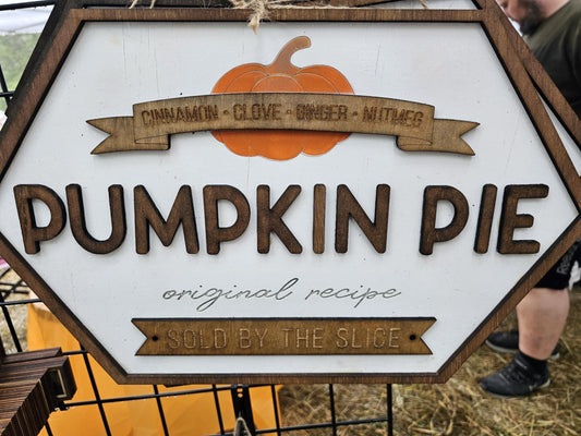 Wooden custom sign for pumpkin pie with orange pumpkin graphic, featuring ingredients and rustic font