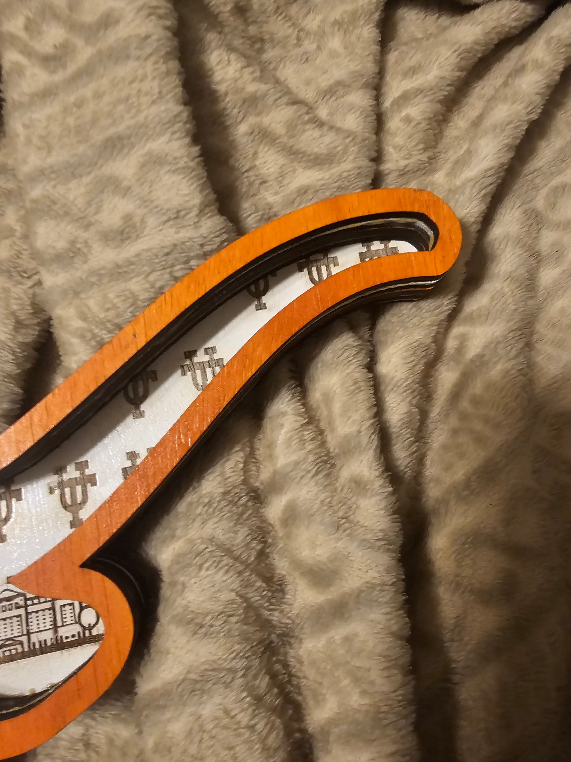 Custom sports sign with orange trim on a soft beige blanket, Bearnugget fan art decor