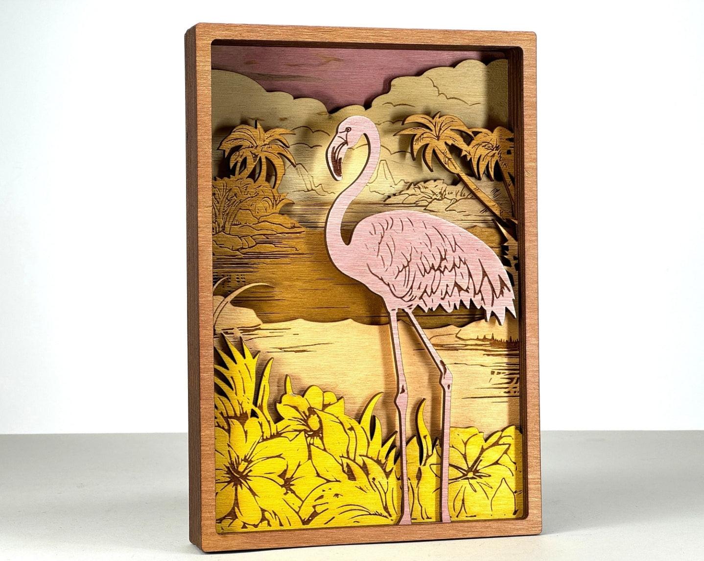 Layered wood art sign of a pink flamingo with tropical flowers and palm trees, Bearnugget Customs.